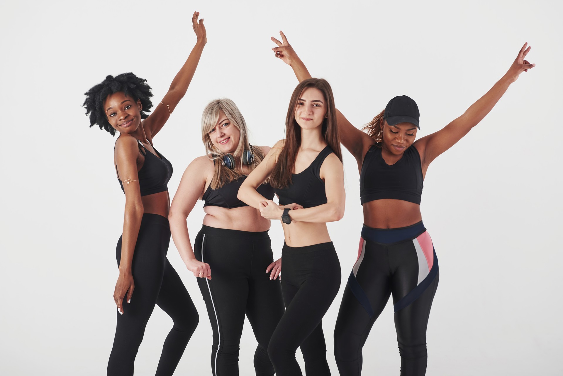 Group of diverse women in activewear celebrating fitness and body positivity - Rewind Time Kansas event