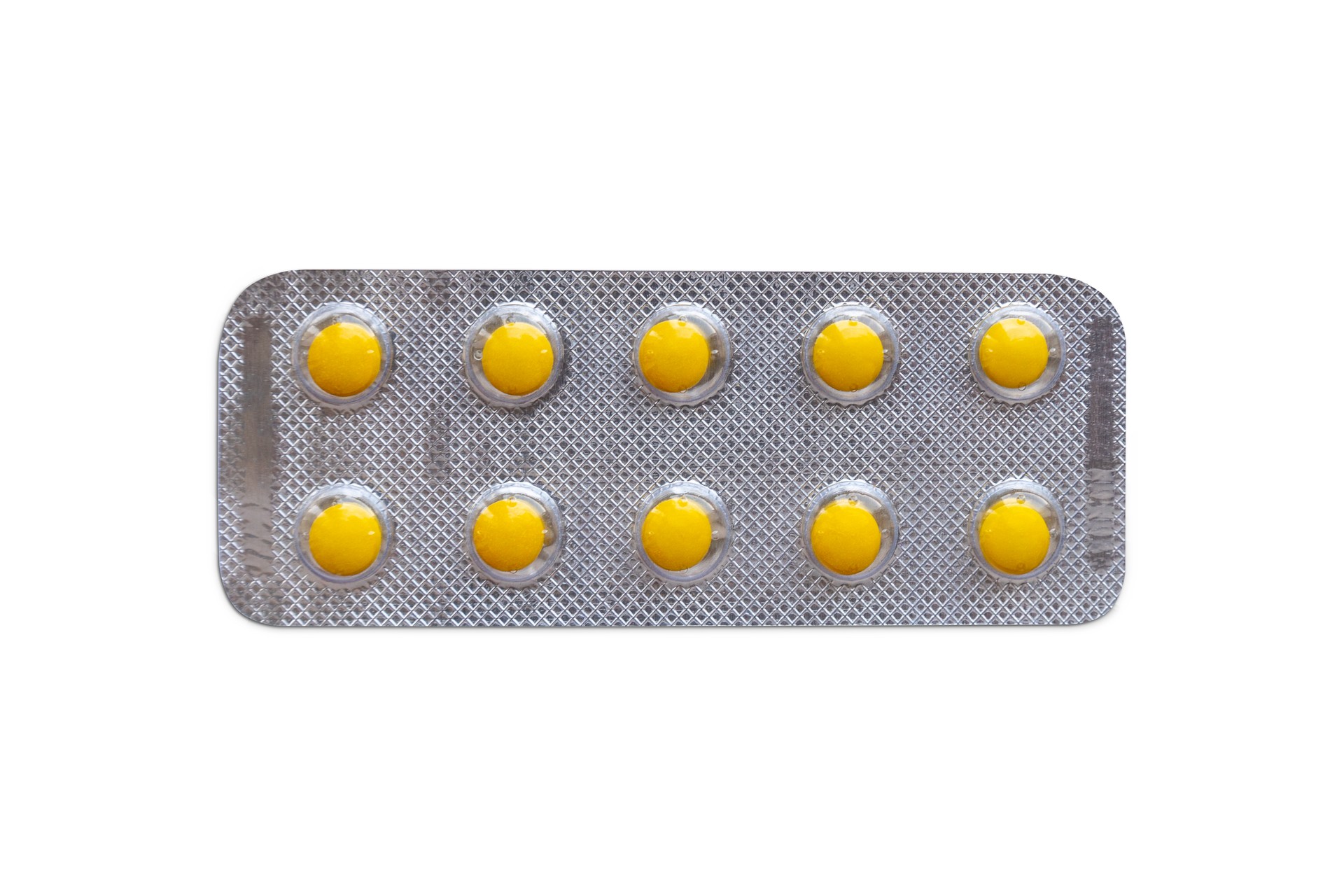 Small blister pills isolated on white background.