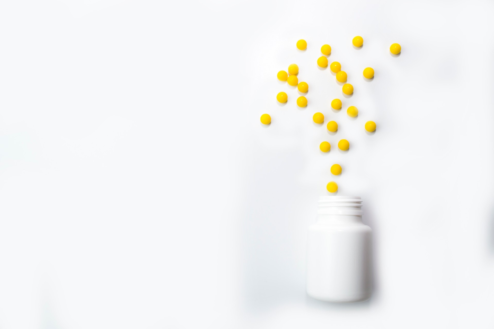 Yellow round tablets or vitamins in a white bubble, on a white background. Concept of medicine. Alternative homeopathy. Flatley. The view from the top. copyright for text.