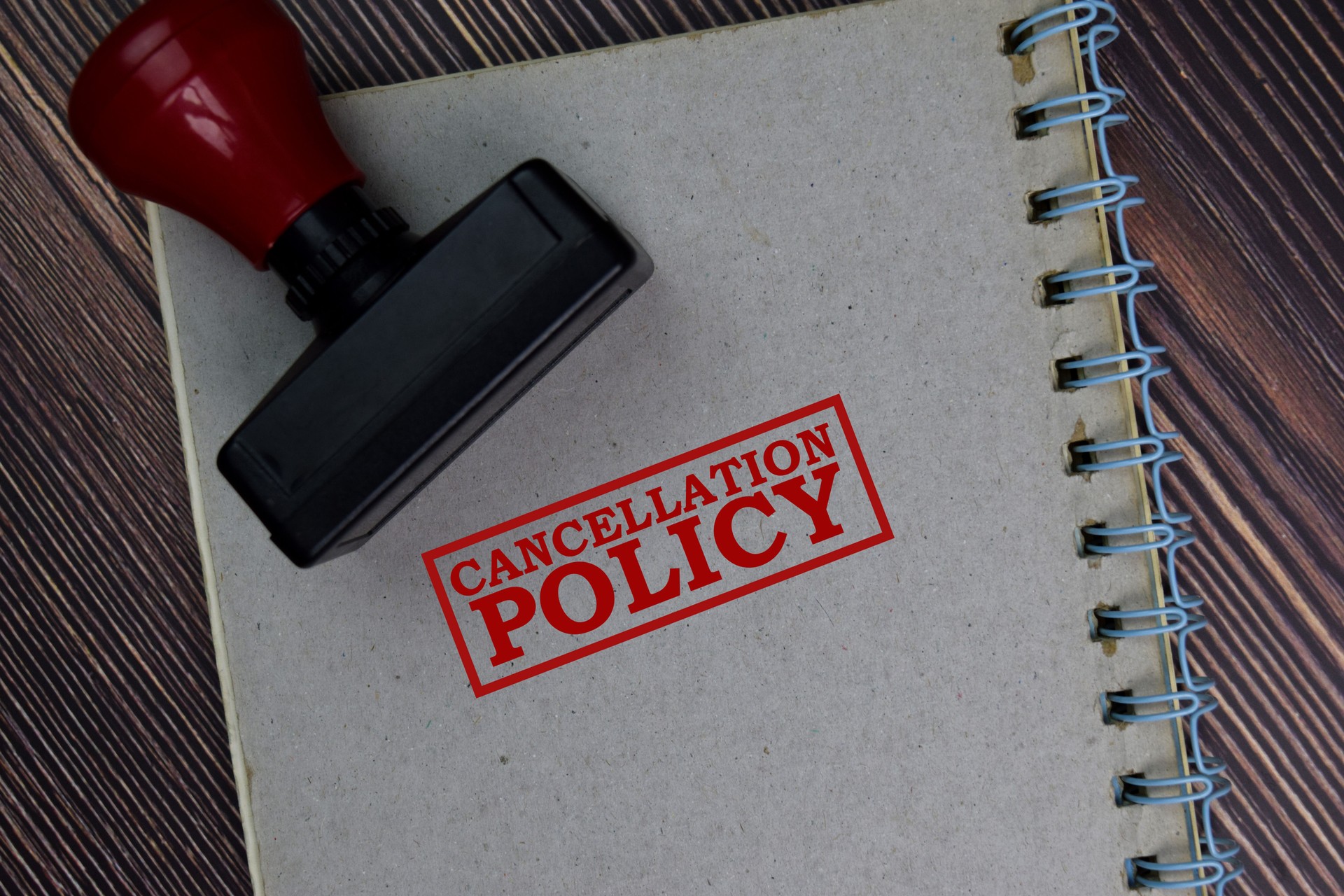 Red Handle Rubber Stamper and Cancellation Policy text isolated on the table.