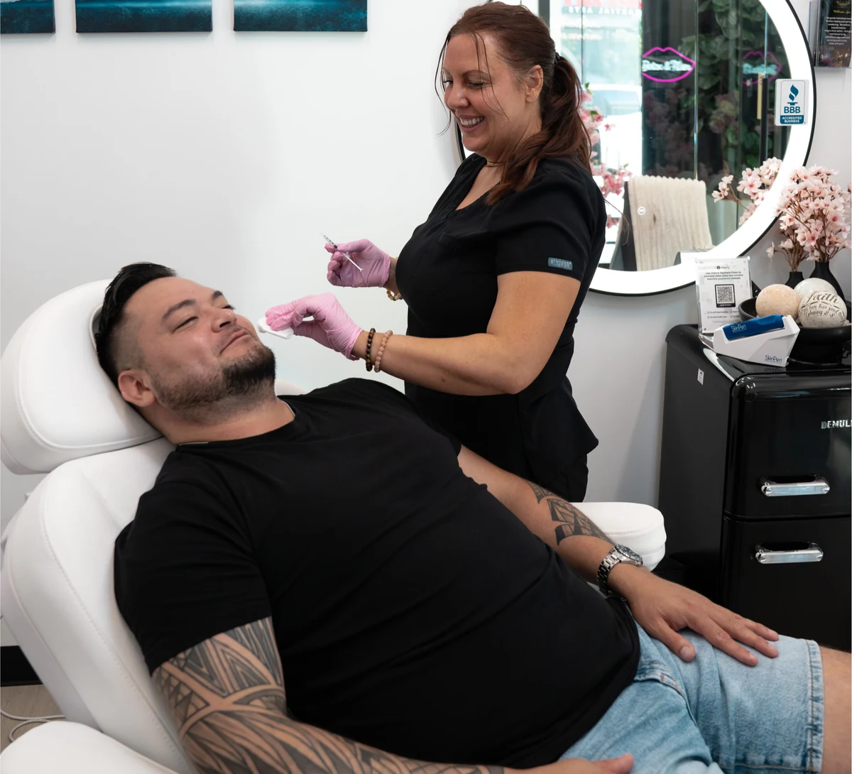 Rewind Time Anti-Aging & Aesthetics in Lenexa, KS — male client in the treatment chair receiving an aesthetic treatment from nurse practitioner Laura McDonald